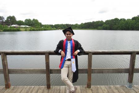 Graduate in front of lake