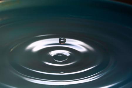 Photo by Levi XU on Unsplash (a drop of water falls into ripples in a body of water)